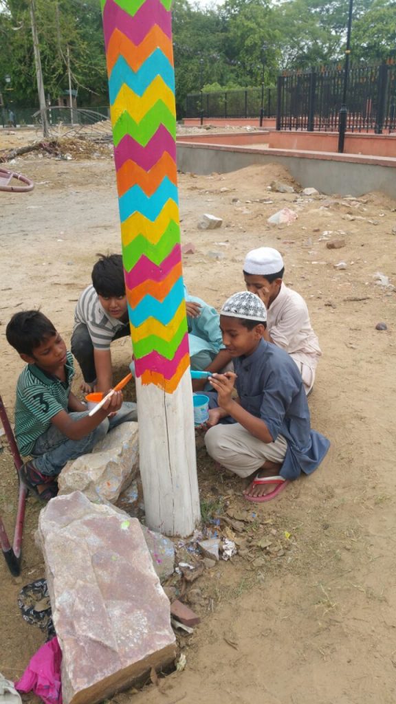 Children from the neighbourhood areas also join in the painting process